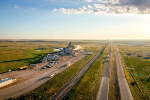 Aerial view of a Prairie Fresh processing facility alongside a highway and railroad