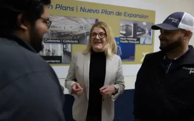 Three individuals having a discussion at a Prairie Fresh facility